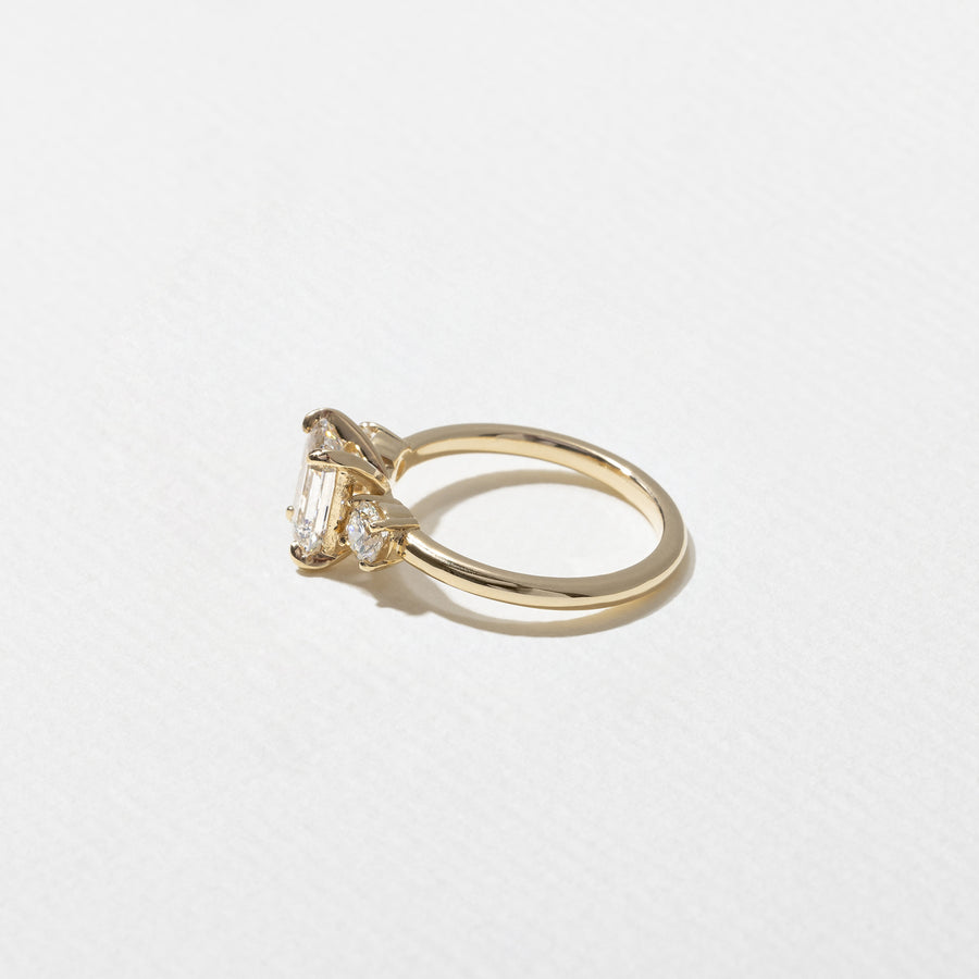 1.29 carat emerald cut lab grown diamond three stone engagement ring in G/VS1 clarity with baguette side stones and polished metal band