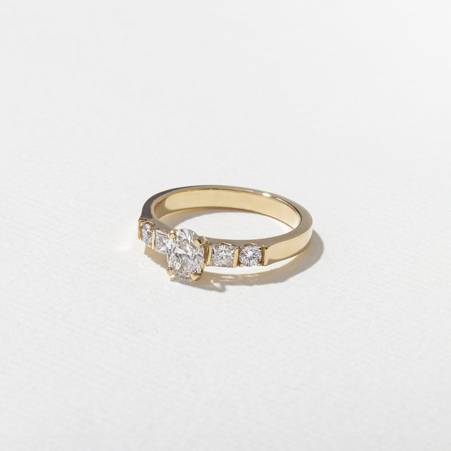 0.50 carat oval cut lab grown diamond five stone engagement ring in classic prong setting on polished gold band