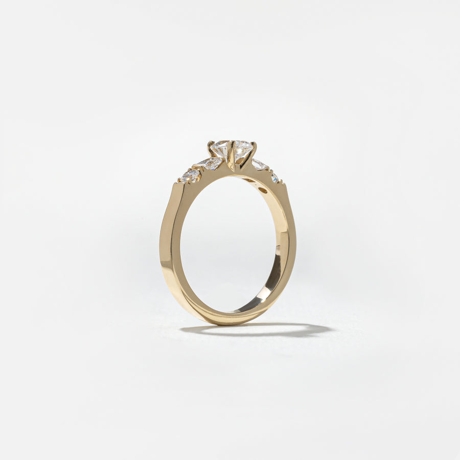 0.50 carat oval cut lab grown diamond five stone engagement ring in classic prong setting on polished gold band