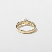 0.50 carat oval cut lab grown diamond five stone engagement ring in classic prong setting on polished gold band