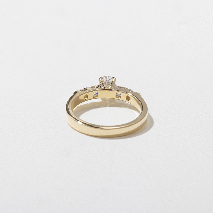 0.50 carat oval cut lab grown diamond five stone engagement ring in classic prong setting on polished gold band