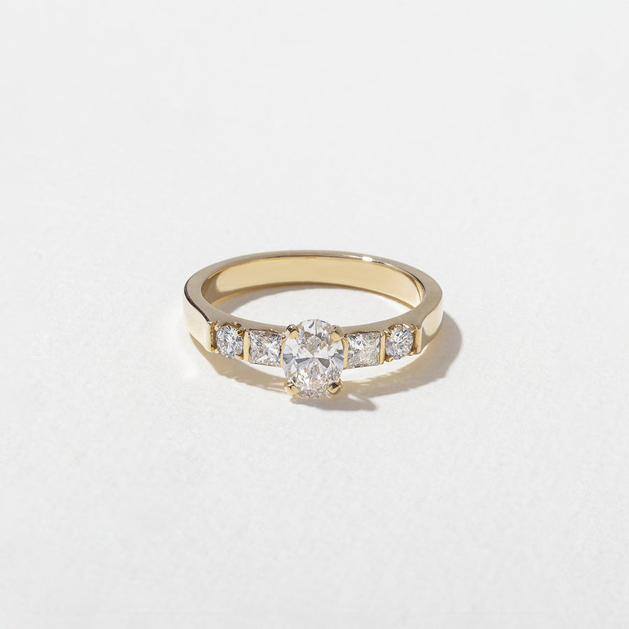 0.50 carat oval cut lab grown diamond five stone engagement ring in classic prong setting on polished gold band