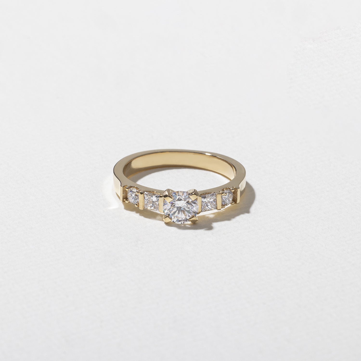 0.50 carat round cut lab grown diamond five stone engagement ring with classic prong setting on gold band for timeless, elegant sparkle