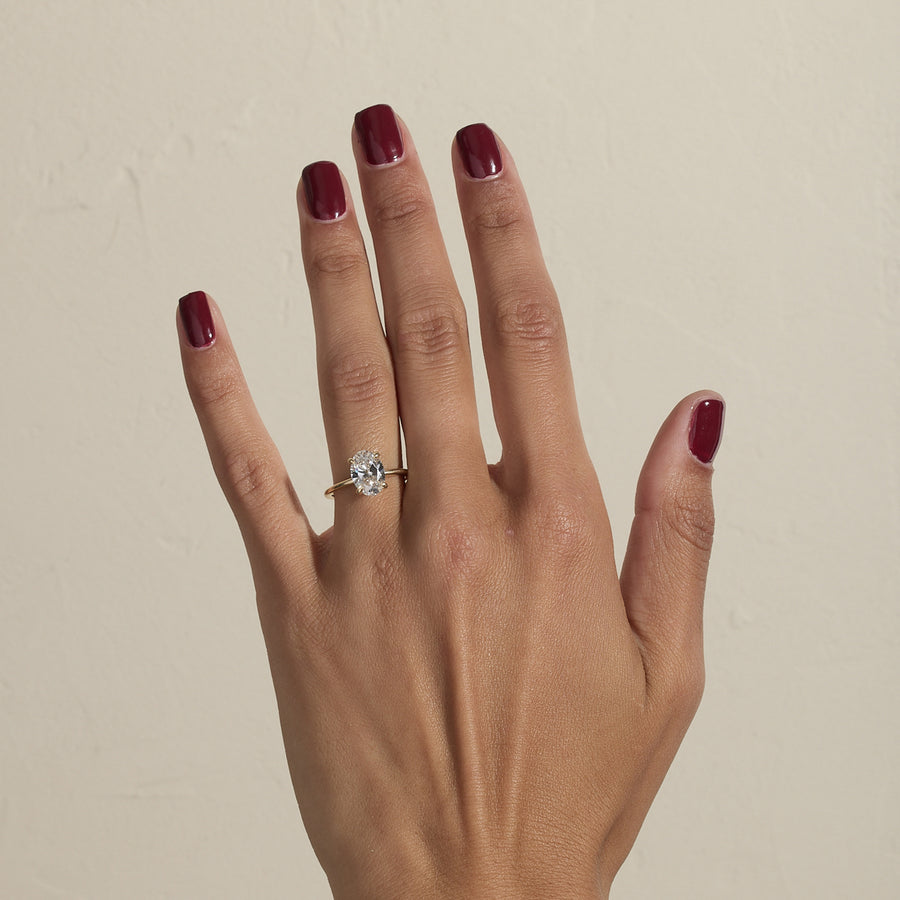 2.04 to 4.04 carat oval lab grown diamond solitaire ring in G/VS1 clarity set in a classic four-prong setting with polished metal band

