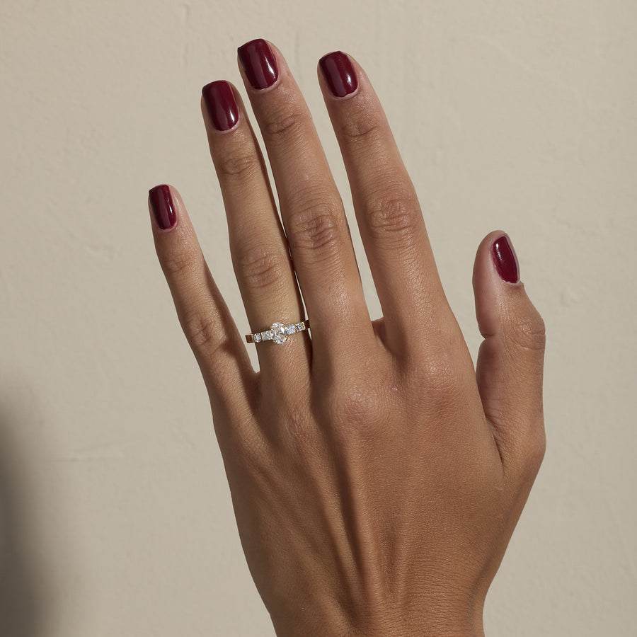 0.50 carat oval cut lab grown diamond five stone engagement ring in classic prong setting on polished gold band