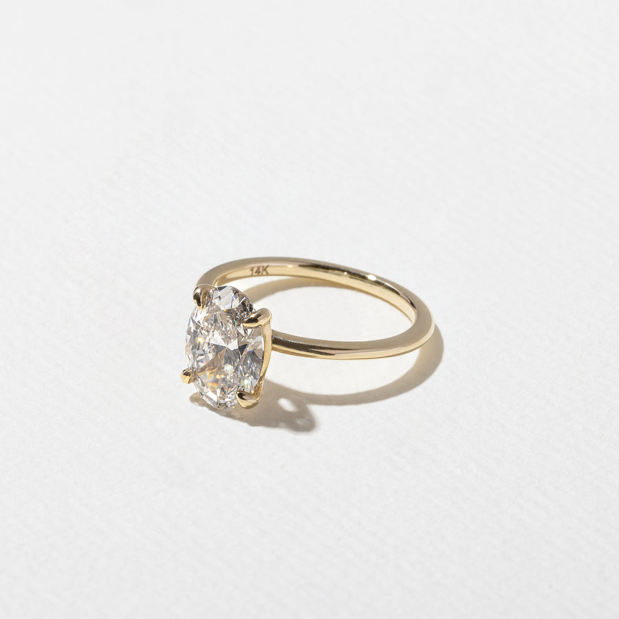 2.04 to 4.04 carat oval lab grown diamond solitaire ring in G/VS1 clarity set in a classic four-prong setting with polished metal band

