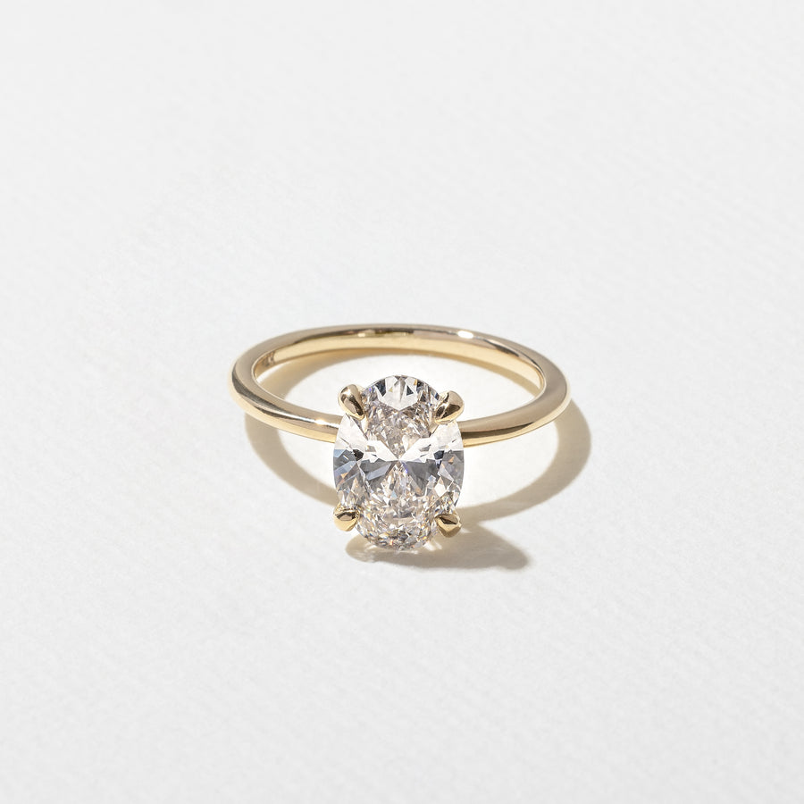 2.04 to 4.04 carat oval lab grown diamond solitaire ring in G/VS1 clarity set in a classic four-prong setting with polished metal band

