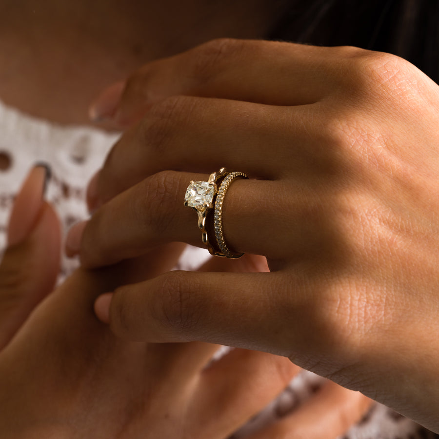 1.35 to 3.35 carat cushion cut lab grown diamond solitaire ring in G/VS1 clarity with soft edges and a polished metal four-prong setting

