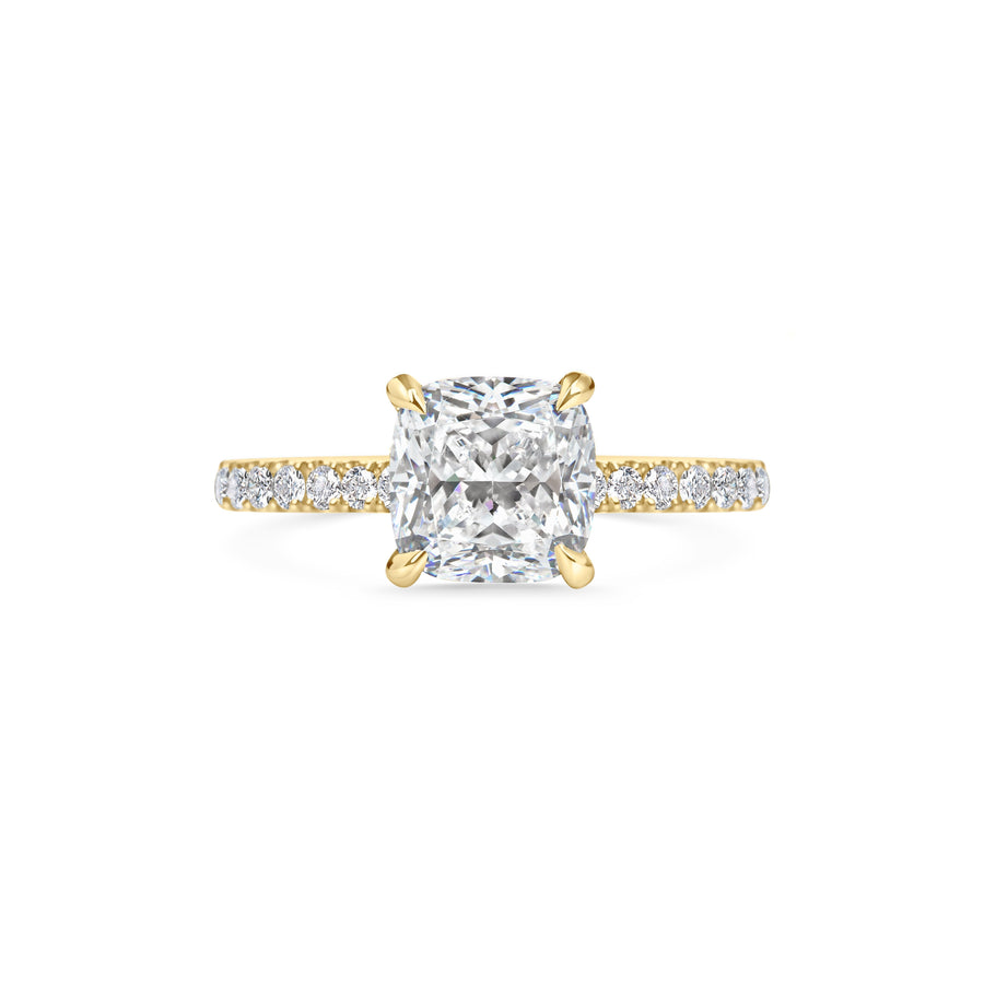 Cushion cut lab grown diamond engagement ring with pavé side stones set in polished gold band, showcasing brilliance and elegance