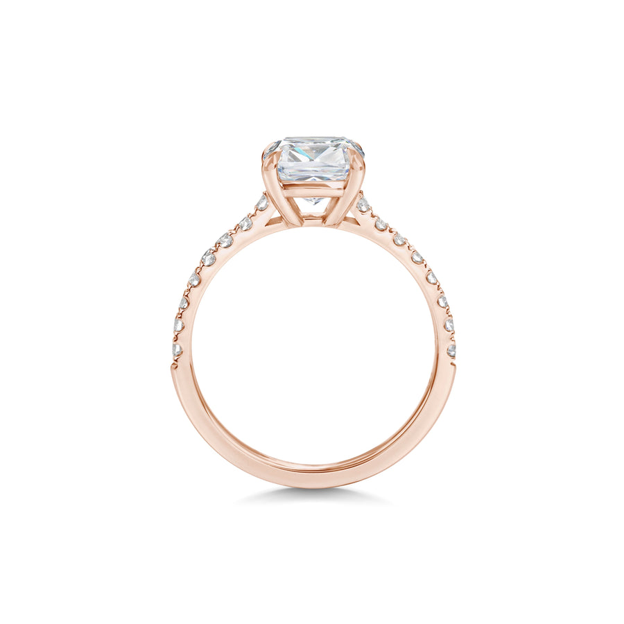 Cushion cut lab grown diamond engagement ring with pavé side stones set in polished gold band, showcasing brilliance and elegance
