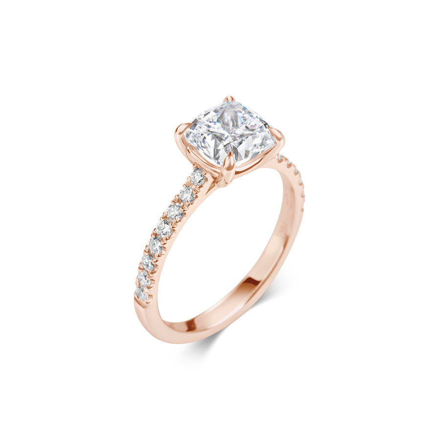 Cushion cut lab grown diamond engagement ring with pavé side stones set in polished gold band, showcasing brilliance and elegance