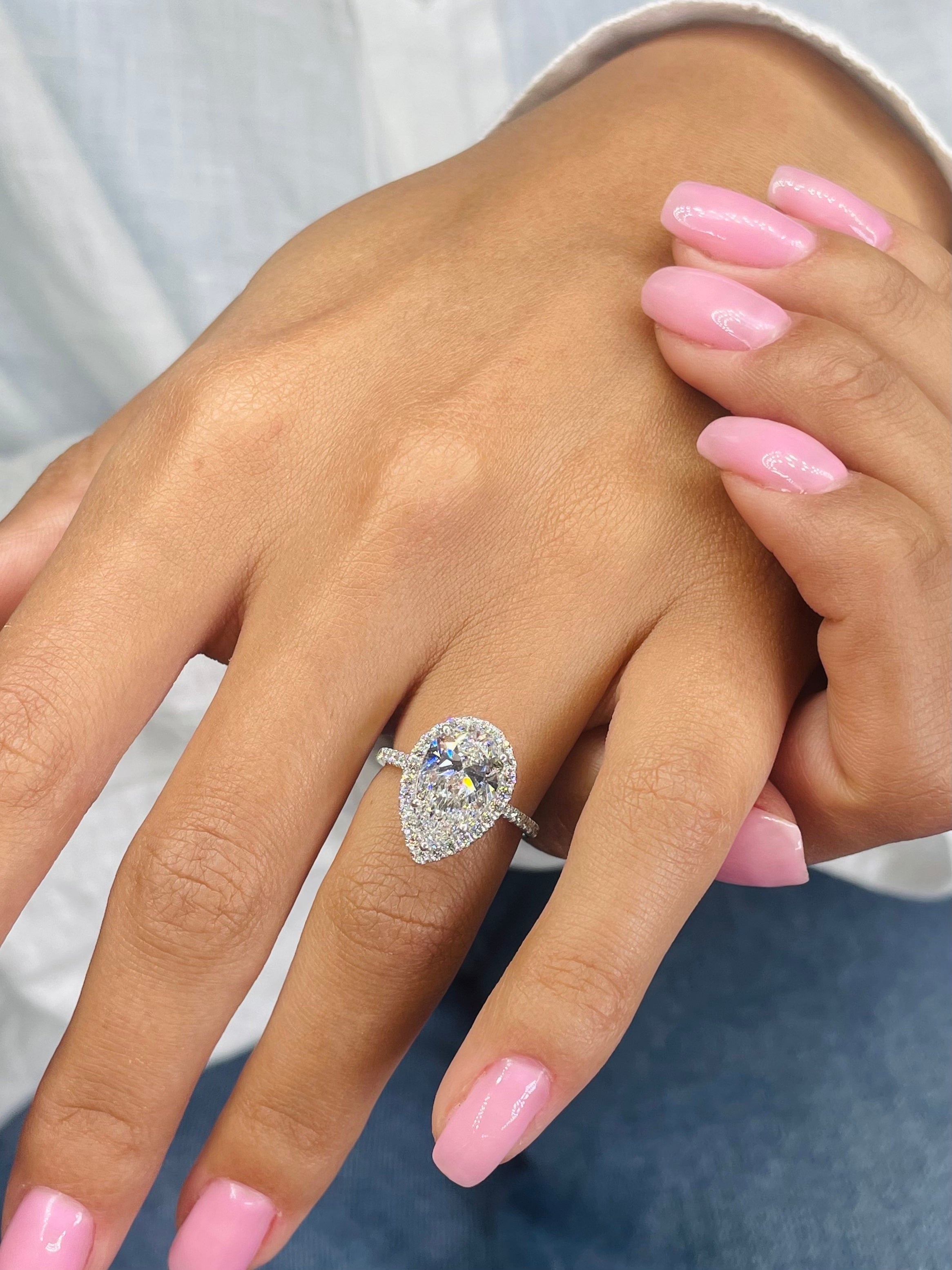 Radiant cut lab grown diamond pavé engagement ring with side stones, set in polished gold band for a modern and elegant style