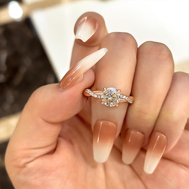 Round cut lab grown diamond engagement ring with twisted pavé band in polished gold, modern and elegant ethical jewelry design