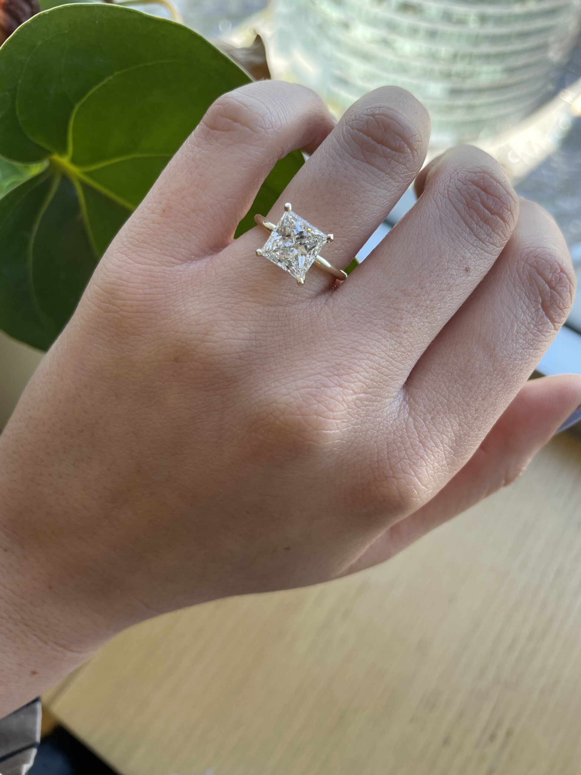 Princess cut lab grown diamond solitaire engagement ring in classic prong setting on polished gold band