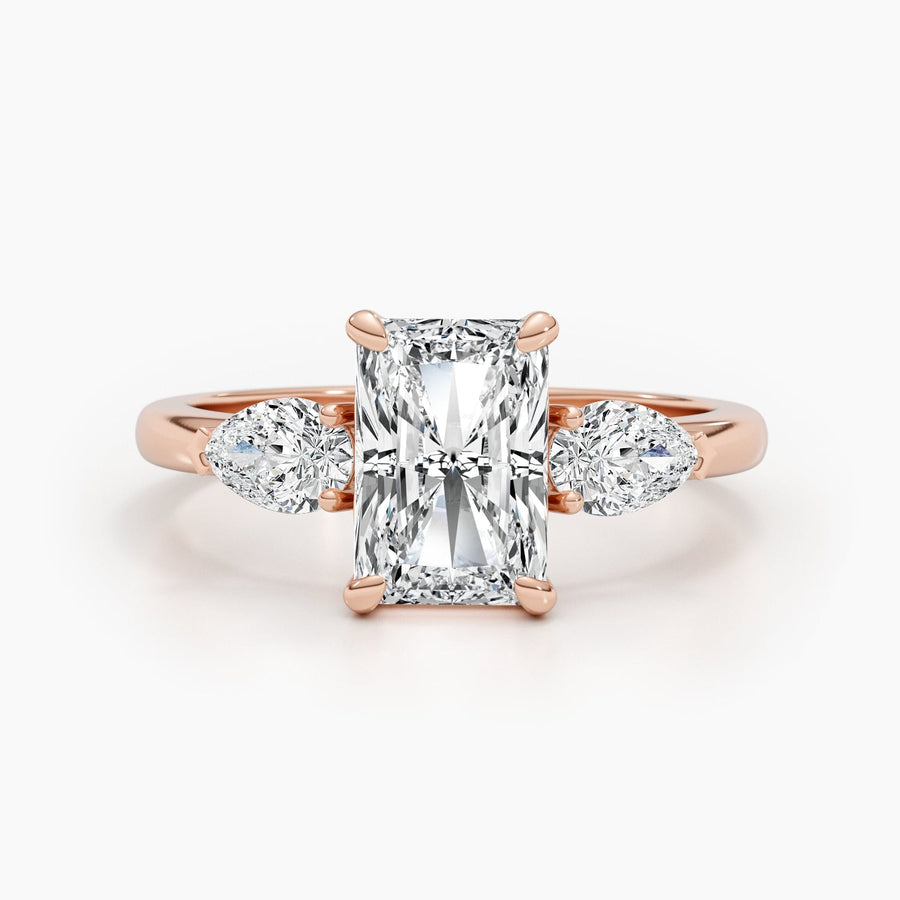 Three stone radiant cut lab grown diamond engagement ring with prong settings on polished gold band, showcasing elegant sparkle