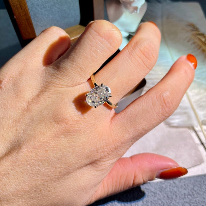 Oval cut lab grown diamond solitaire engagement ring set in a classic prong design on a polished gold band