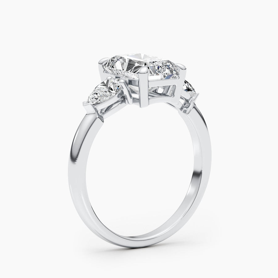 Three stone radiant cut lab grown diamond engagement ring with prong settings on polished gold band, showcasing elegant sparkle