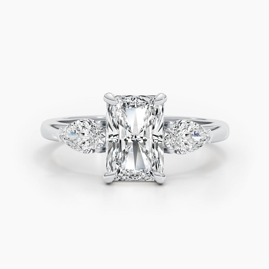 Three stone radiant cut lab grown diamond engagement ring with prong settings on polished gold band, showcasing elegant sparkle
