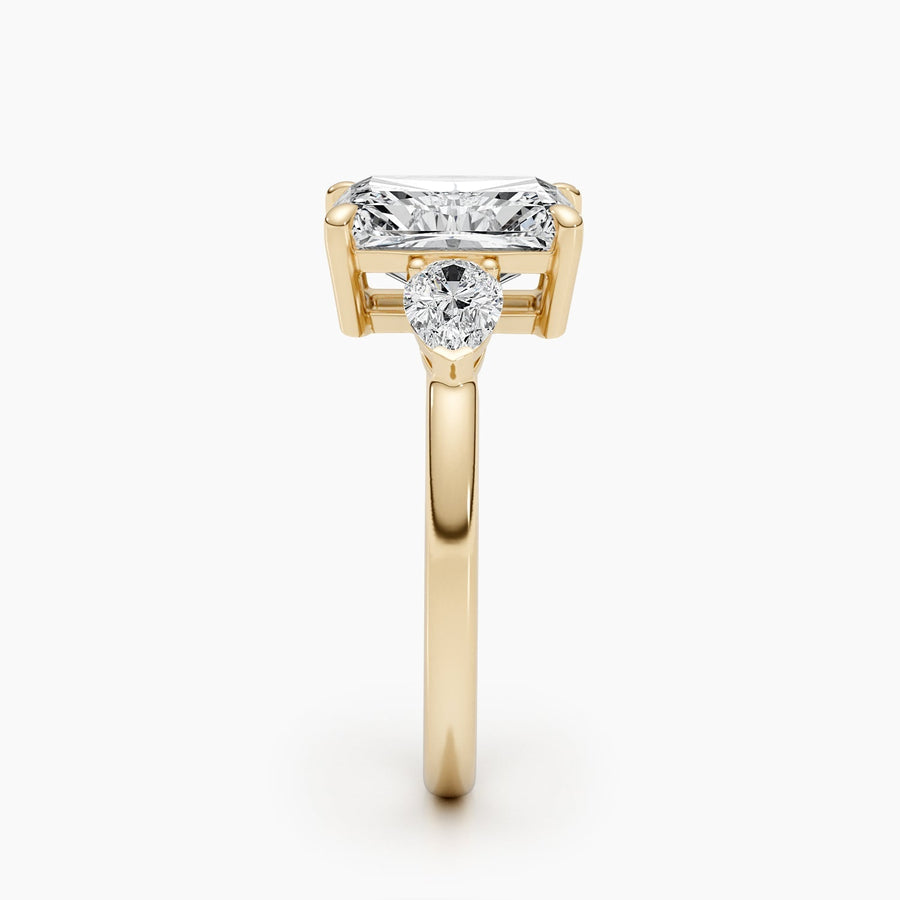 Three stone radiant cut lab grown diamond engagement ring with prong settings on polished gold band, showcasing elegant sparkle