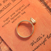 Emerald cut lab grown diamond solitaire engagement ring set in a classic prong design on polished gold band