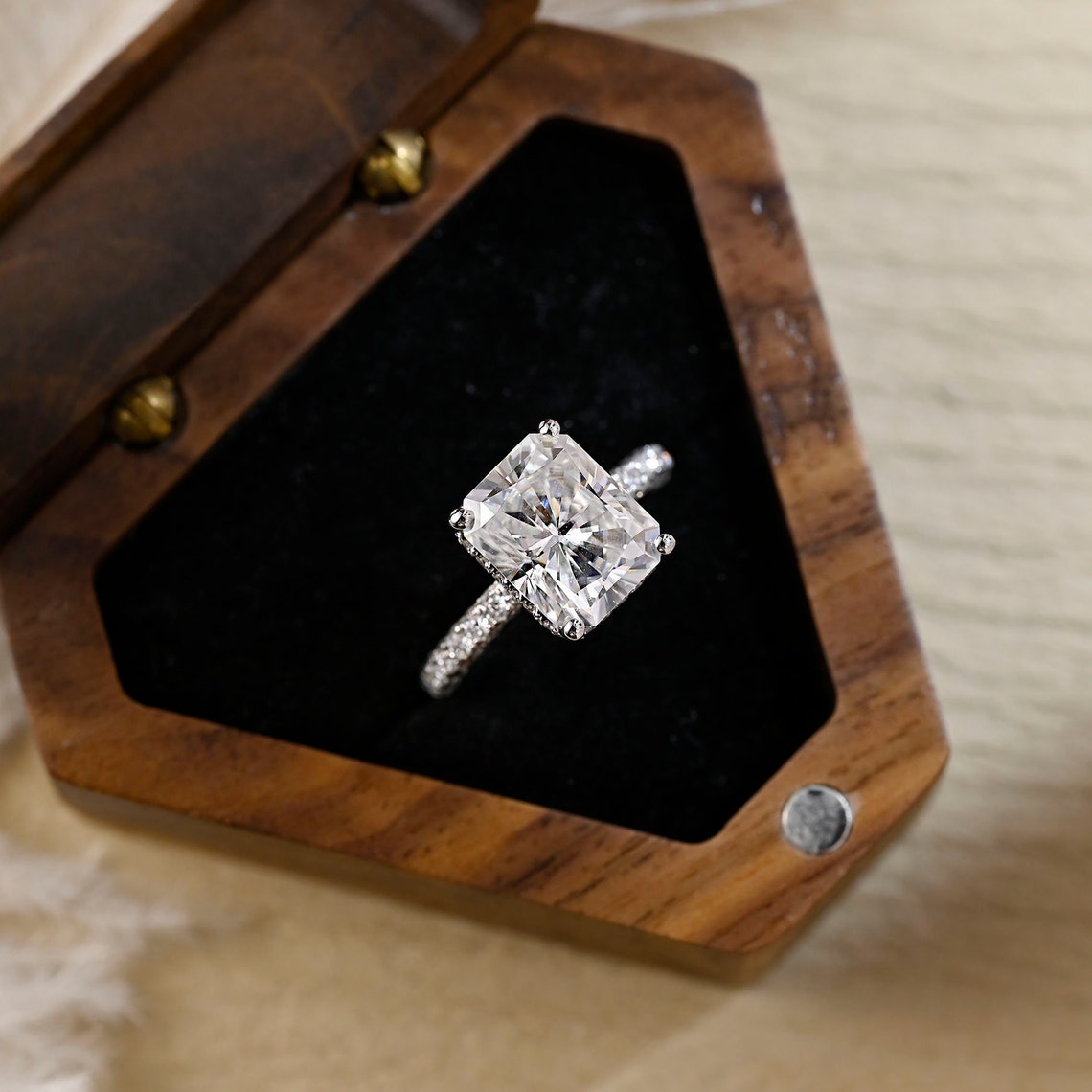 Radiant cut lab grown diamond pavé engagement ring with side stones set in polished gold band