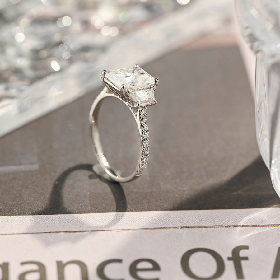 Radiant cut lab grown diamond three stone engagement ring with prong setting on polished gold band