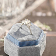 Radiant cut lab grown diamond three stone engagement ring with prong setting on polished gold band