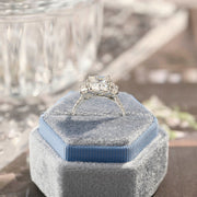 Radiant cut lab grown diamond three stone engagement ring with prong setting on polished gold band