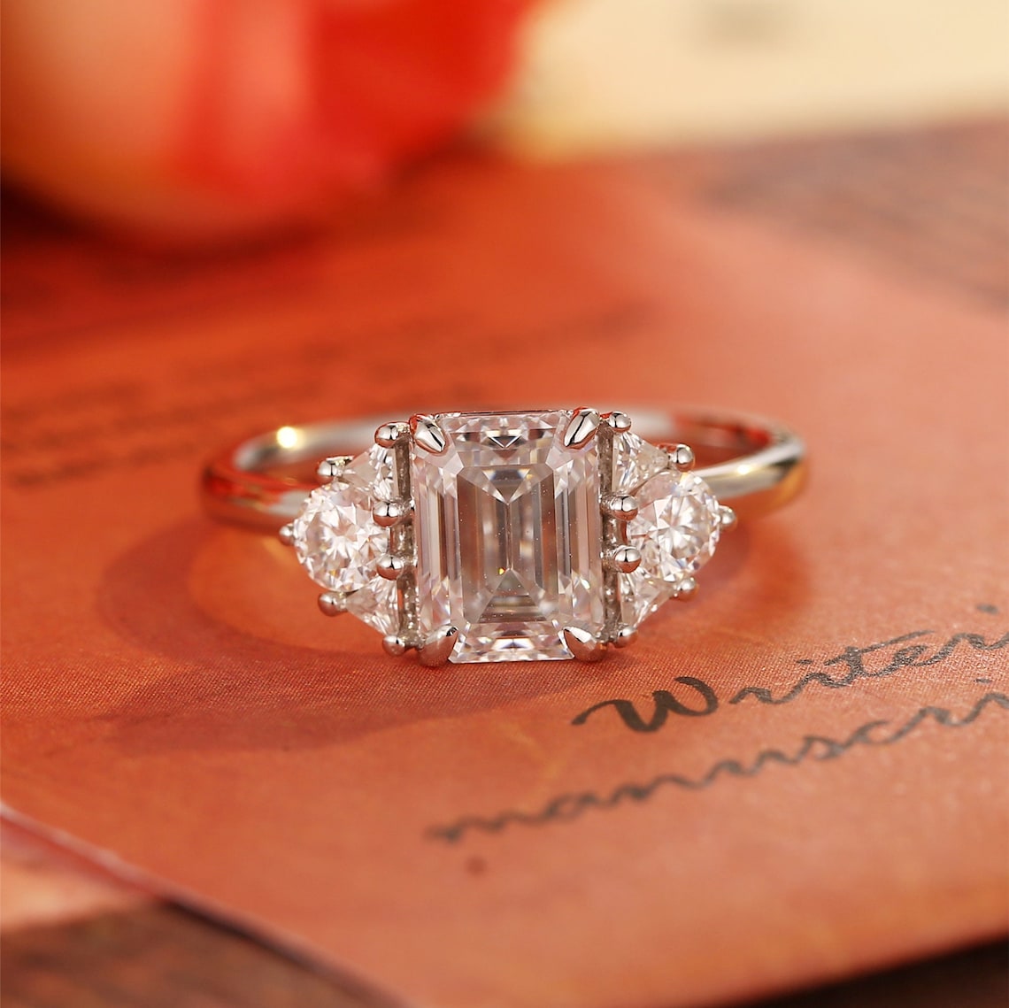 Emerald cut lab grown diamond cluster solitaire engagement ring in prong setting with side stones on polished gold band