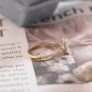 Radiant cut lab grown diamond hidden halo pavé engagement ring with side stones, set in polished gold band