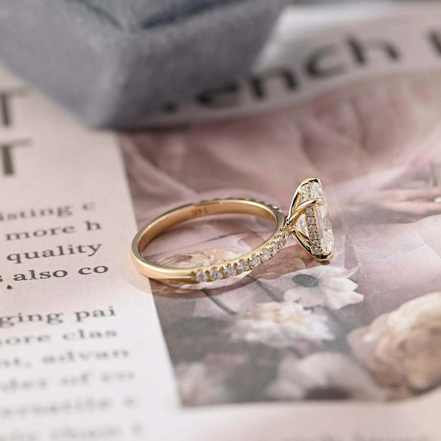 Radiant cut lab grown diamond hidden halo pavé engagement ring with side stones, set in polished gold band