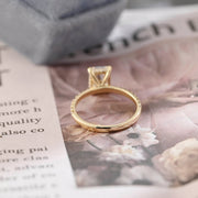 Radiant cut lab grown diamond hidden halo pavé engagement ring with side stones, set in polished gold band