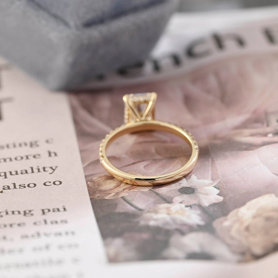 Radiant cut lab grown diamond hidden halo pavé engagement ring with side stones, set in polished gold band