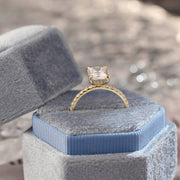 Radiant cut lab grown diamond hidden halo pavé engagement ring with side stones, set in polished gold band