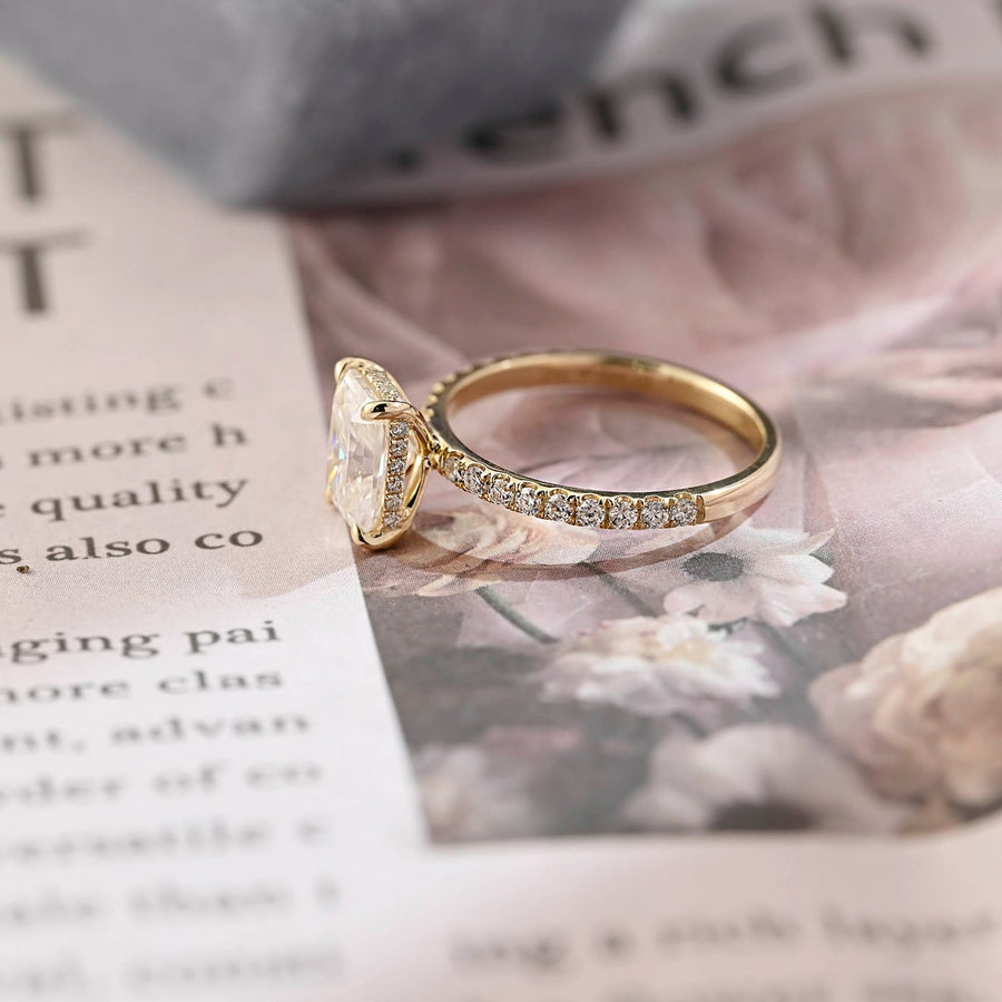 Radiant cut lab grown diamond hidden halo pavé engagement ring with side stones, set in polished gold band