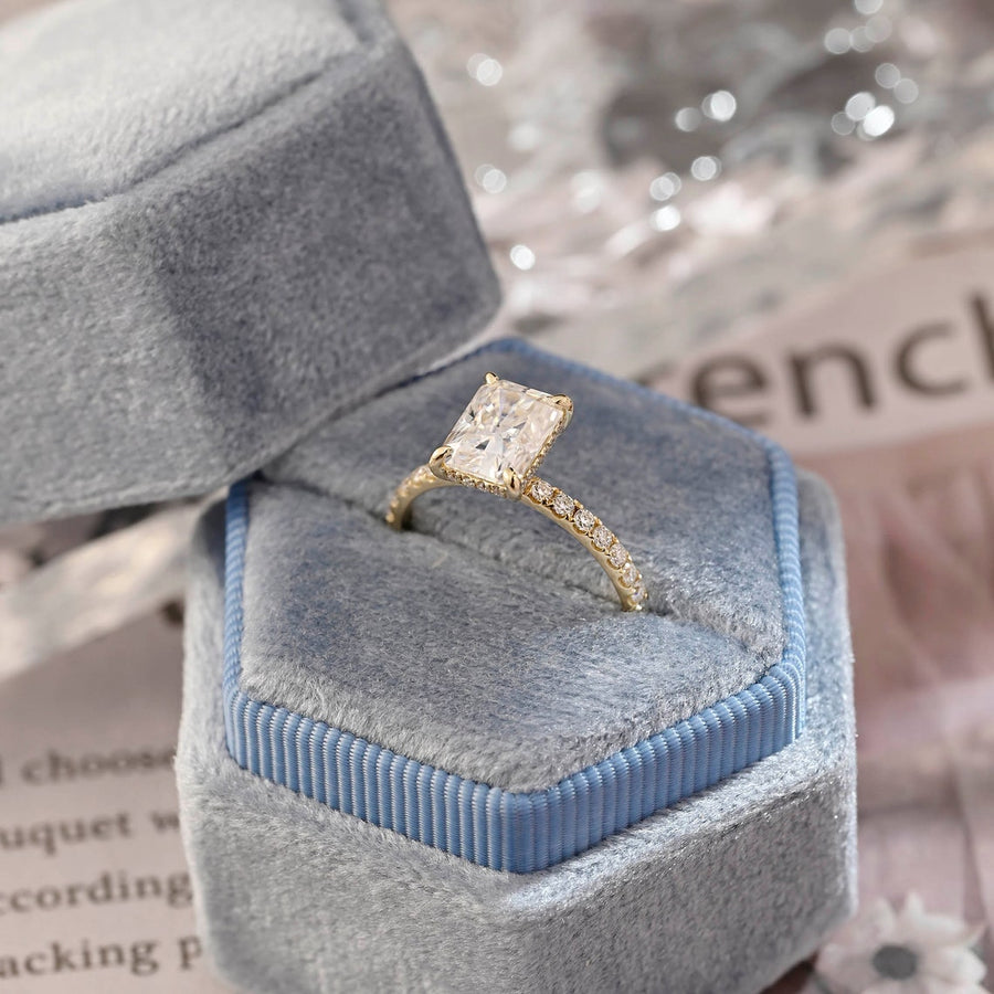 Radiant cut lab grown diamond hidden halo pavé engagement ring with side stones, set in polished gold band