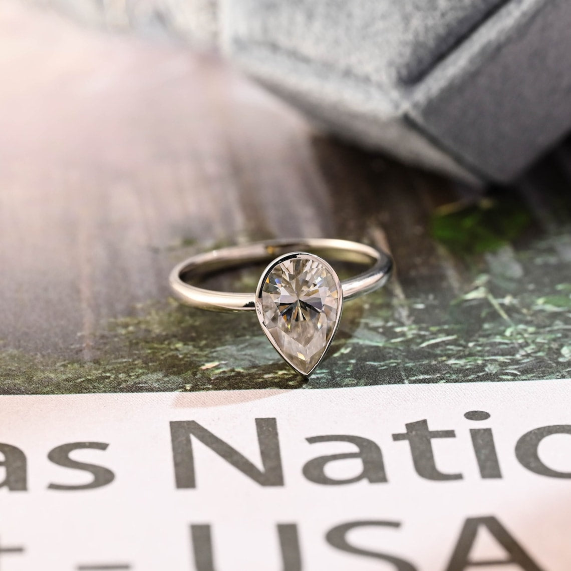 Pear cut lab grown diamond bezel setting engagement ring, 1.0 to 3.0 carats, crafted in polished gold for a modern minimalist look