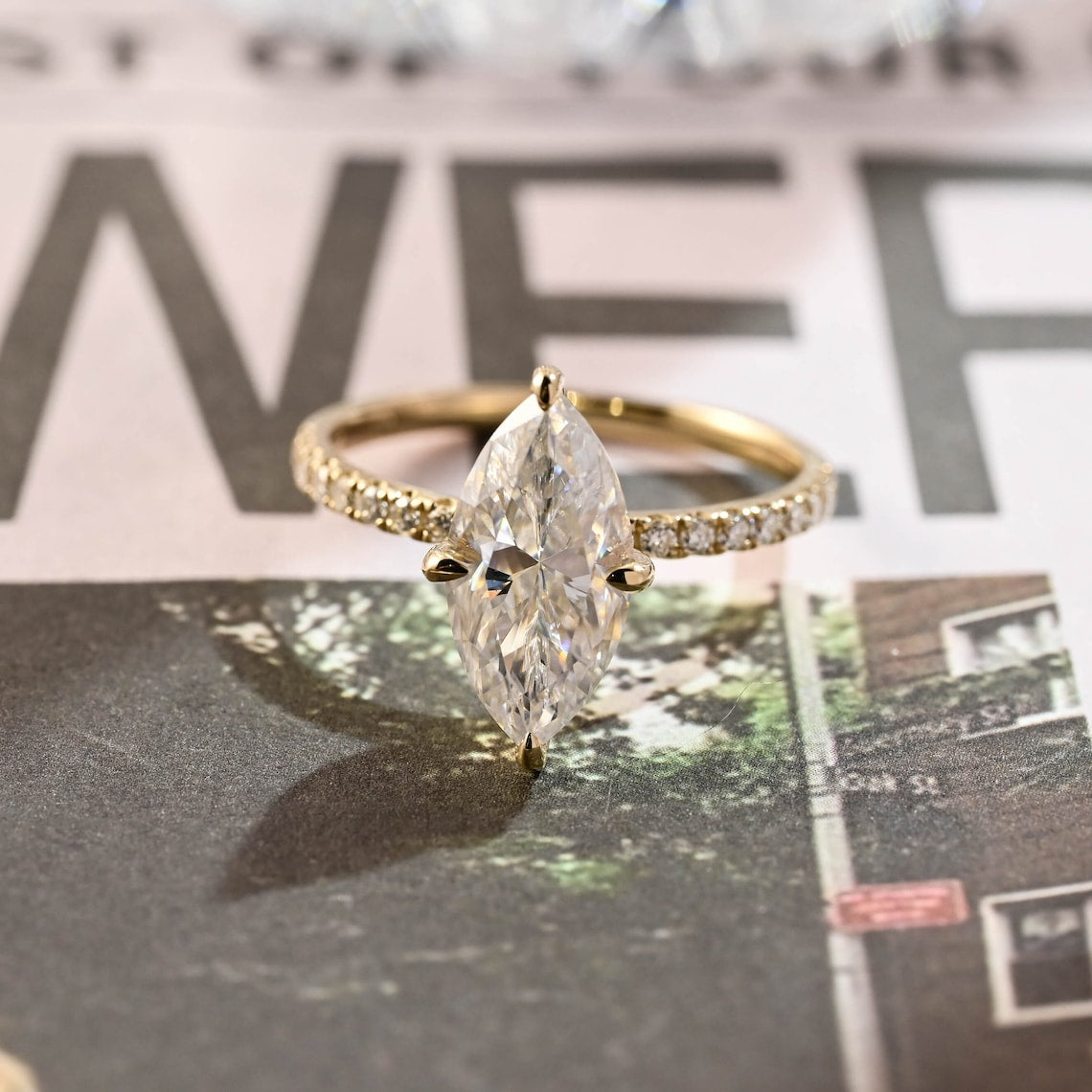 Marquise cut lab grown diamond pavé engagement ring with side stones set in elegant prong setting on polished gold band