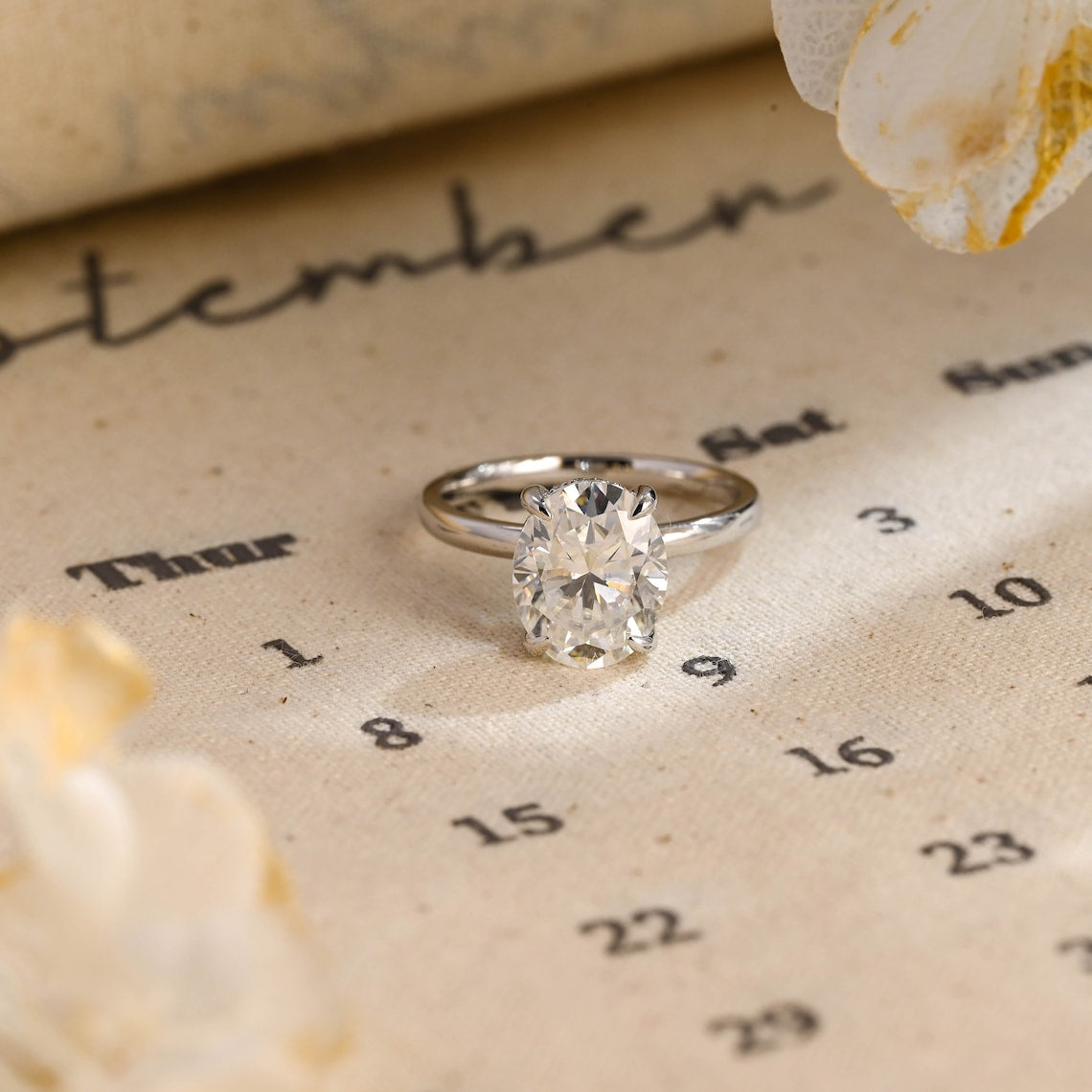 Oval cut lab grown diamond hidden halo engagement ring, 1.0 to 3.0 carats, set in prong design with hidden halo on polished gold band