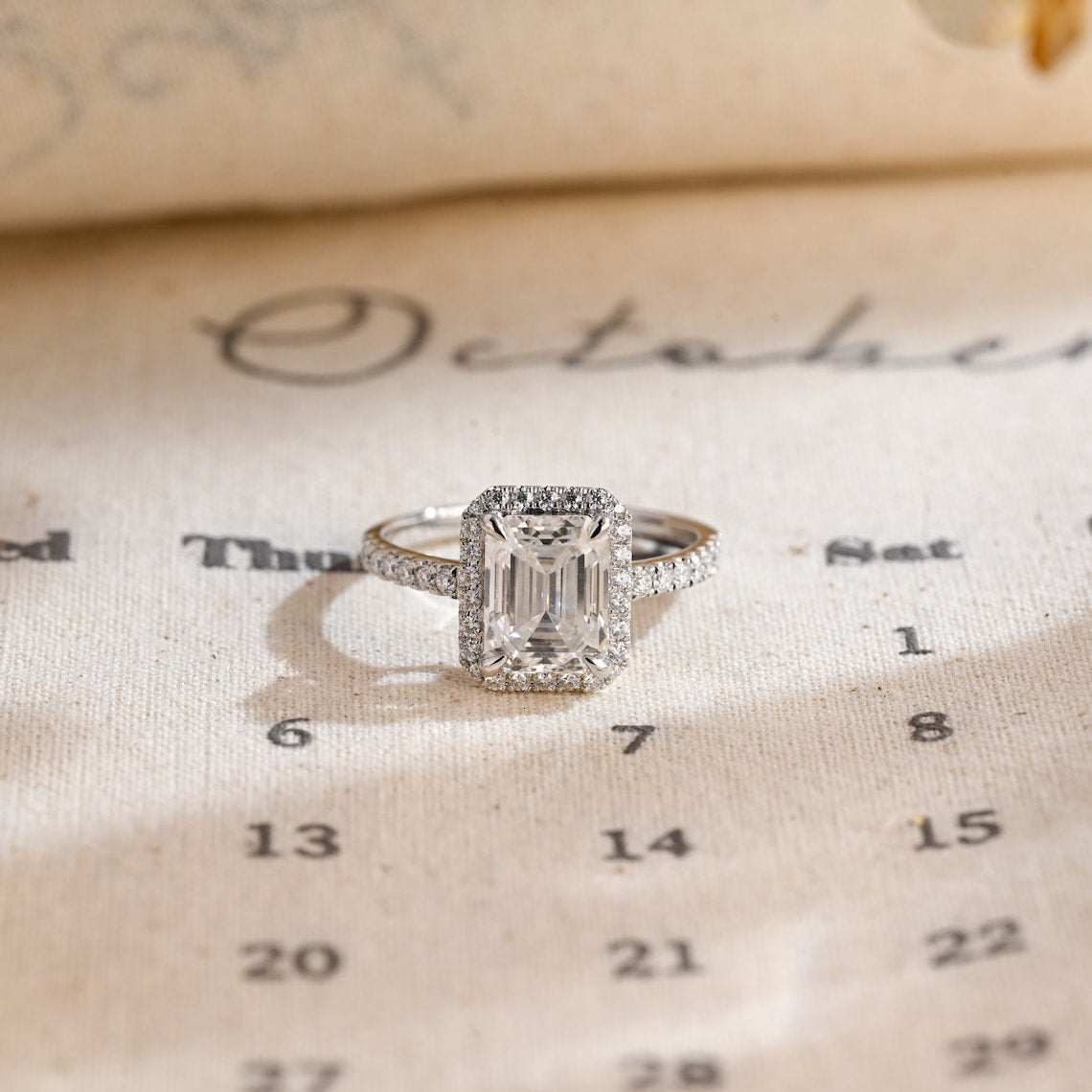 Emerald cut lab grown diamond halo pavé engagement ring, 1.0 to 3.0 carats, set in prong setting with side stones on polished gold band