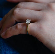 Emerald cut lab grown diamond solitaire engagement ring set in a classic prong design on polished gold band