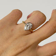 Lab grown diamond engagement ring with pear cut stone in a bezel twisted setting. A unique design that blends modern artistry with timeless romance.