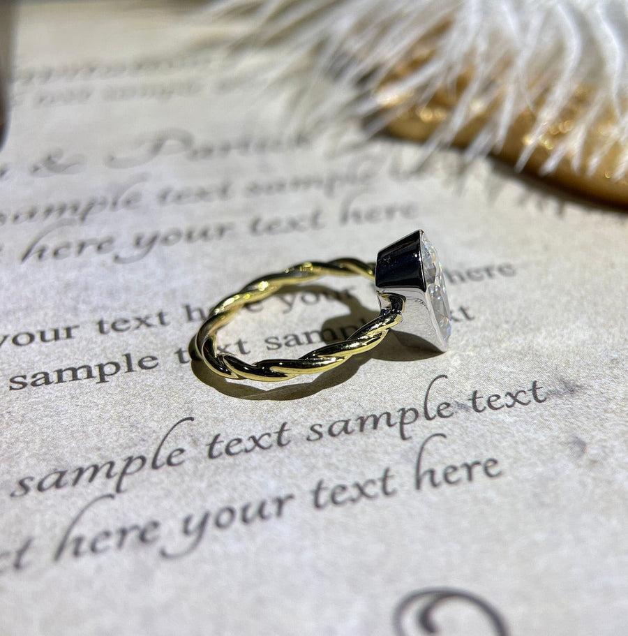 Lab grown diamond engagement ring with pear cut stone in a bezel twisted setting. A unique design that blends modern artistry with timeless romance.