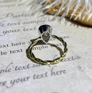 Lab grown diamond engagement ring with pear cut stone in a bezel twisted setting. A unique design that blends modern artistry with timeless romance.