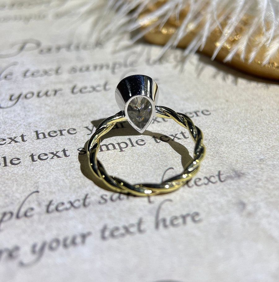 Lab grown diamond engagement ring with pear cut stone in a bezel twisted setting. A unique design that blends modern artistry with timeless romance.
