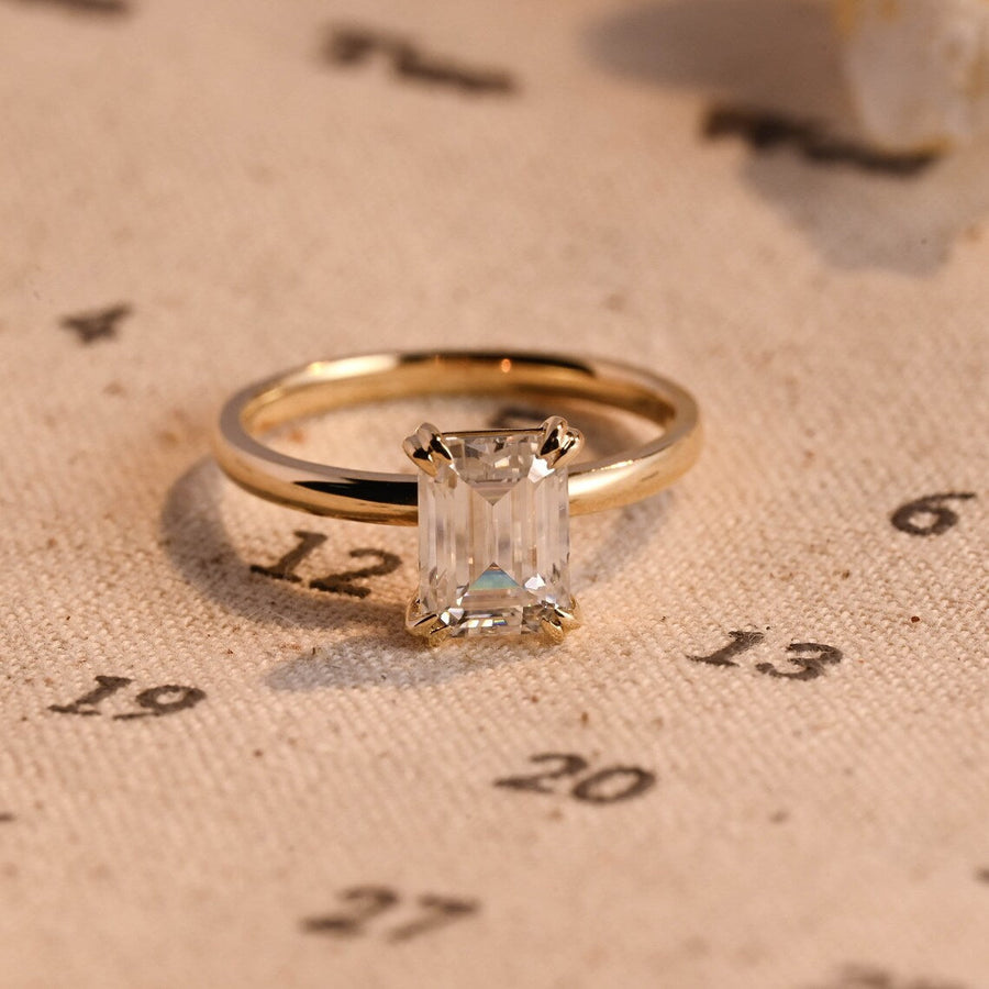 Emerald cut lab grown diamond solitaire engagement ring, 1.0 to 3.0 carats, set in classic prong setting on polished gold band