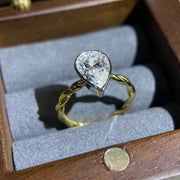 Lab grown diamond engagement ring with pear cut stone in a bezel twisted setting. A unique design that blends modern artistry with timeless romance.