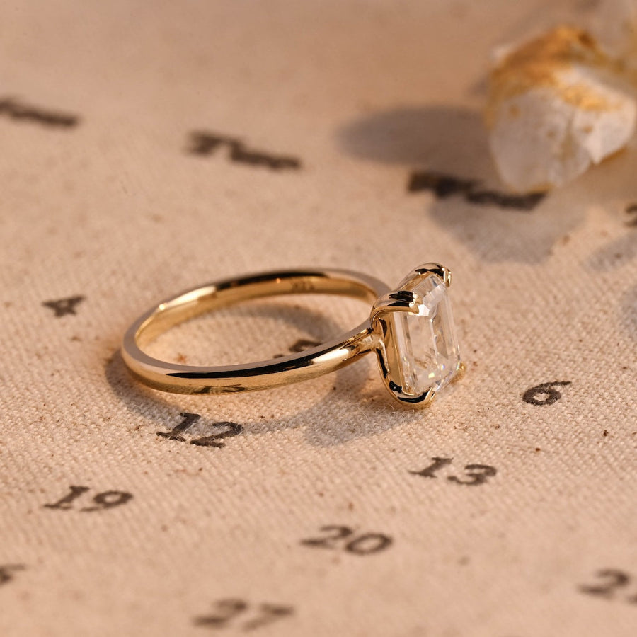 Emerald cut lab grown diamond solitaire engagement ring, 1.0 to 3.0 carats, set in classic prong setting on polished gold band