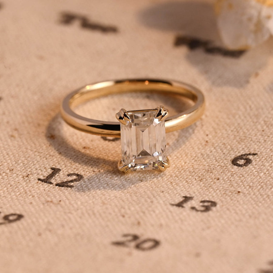 Emerald cut lab grown diamond solitaire engagement ring, 1.0 to 3.0 carats, set in classic prong setting on polished gold band