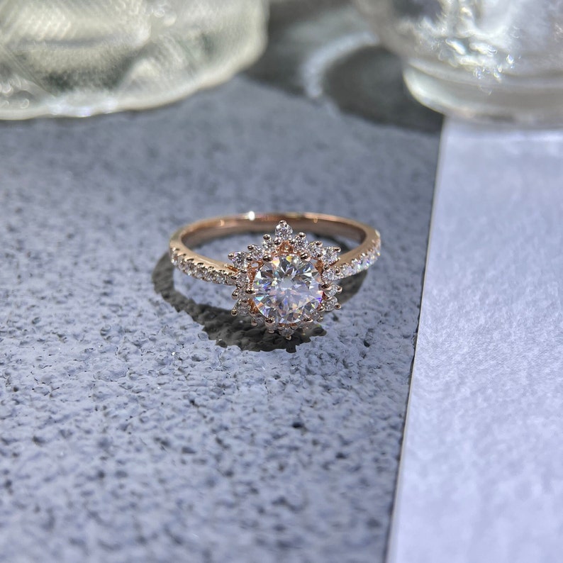 Round cut lab grown diamond halo pavé engagement ring with accent stones in elegant prong setting on polished gold band